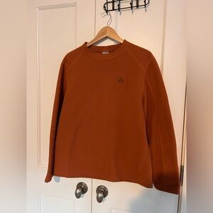 Nike ACG Therma-FIT Fleece Crewneck Sweatshirt in a campfire orange color